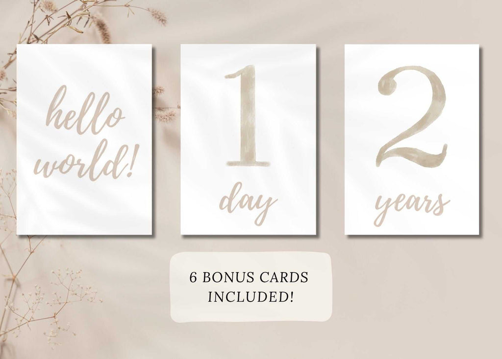 Printable beige baby milestone cards set for 0-2 years with "hello world," "1 day," and "2 years" designs