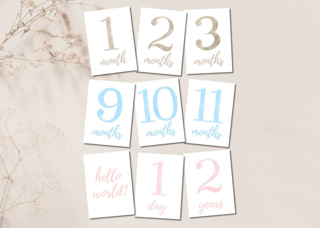 Printable baby milestone cards set in beige, pink, and blue for 0-2 years with months and special milestones.